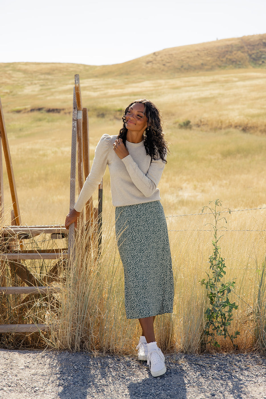 a woman standing next to a wooden ladder