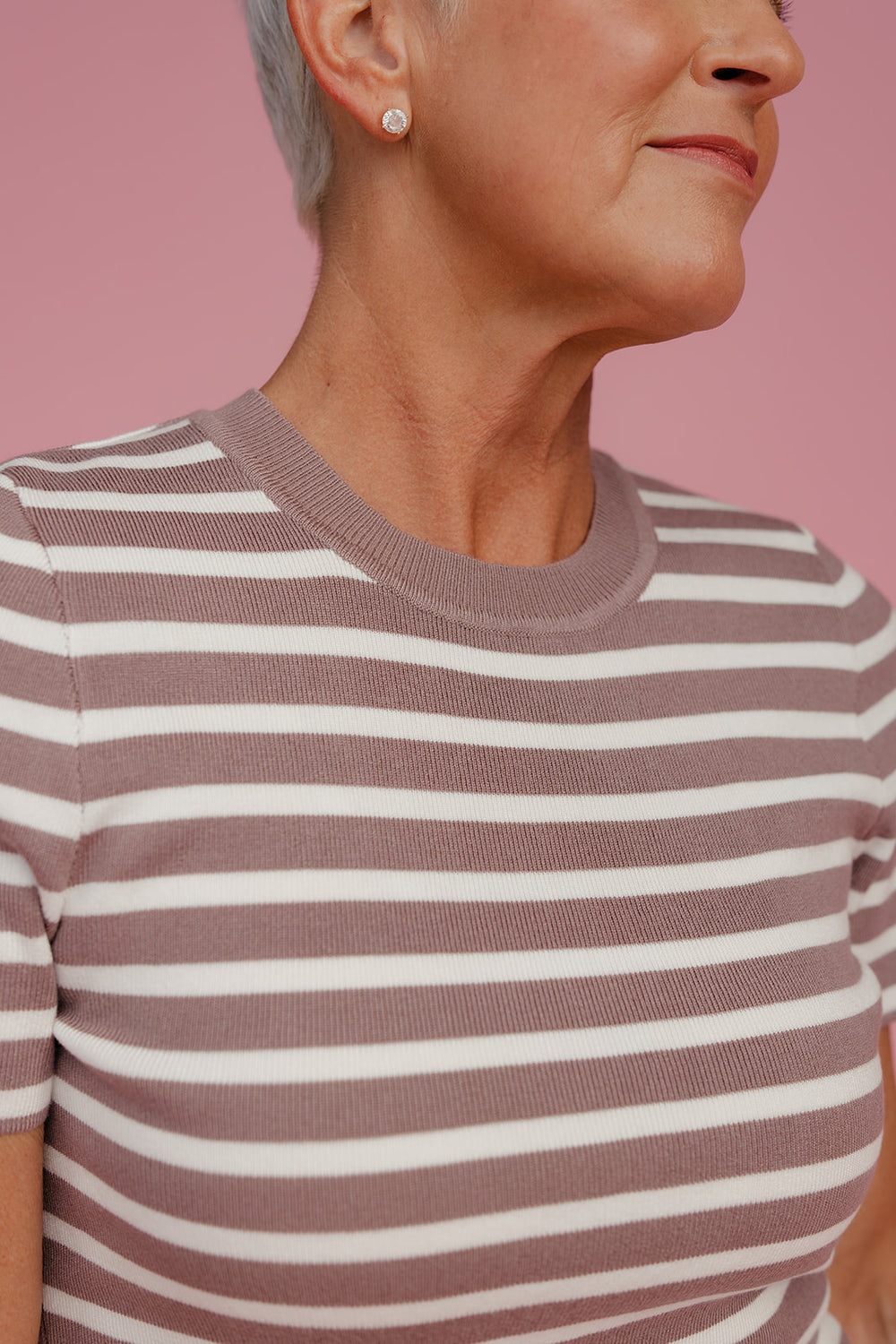 Close up of a woman wearing a brown and white tee