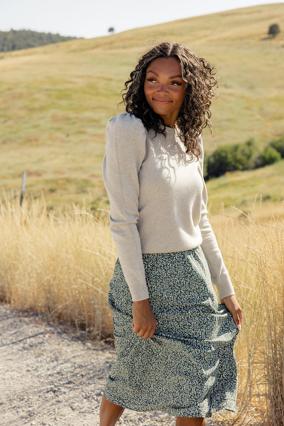 a woman standing outside in a field