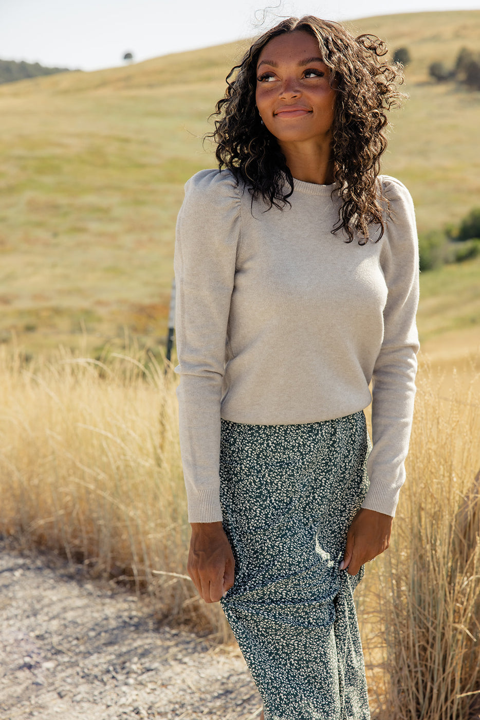 a woman standing outside in a field