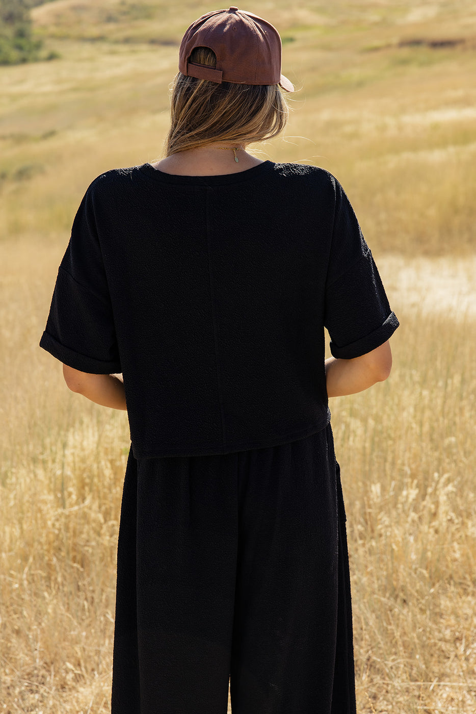 a woman standing in a field