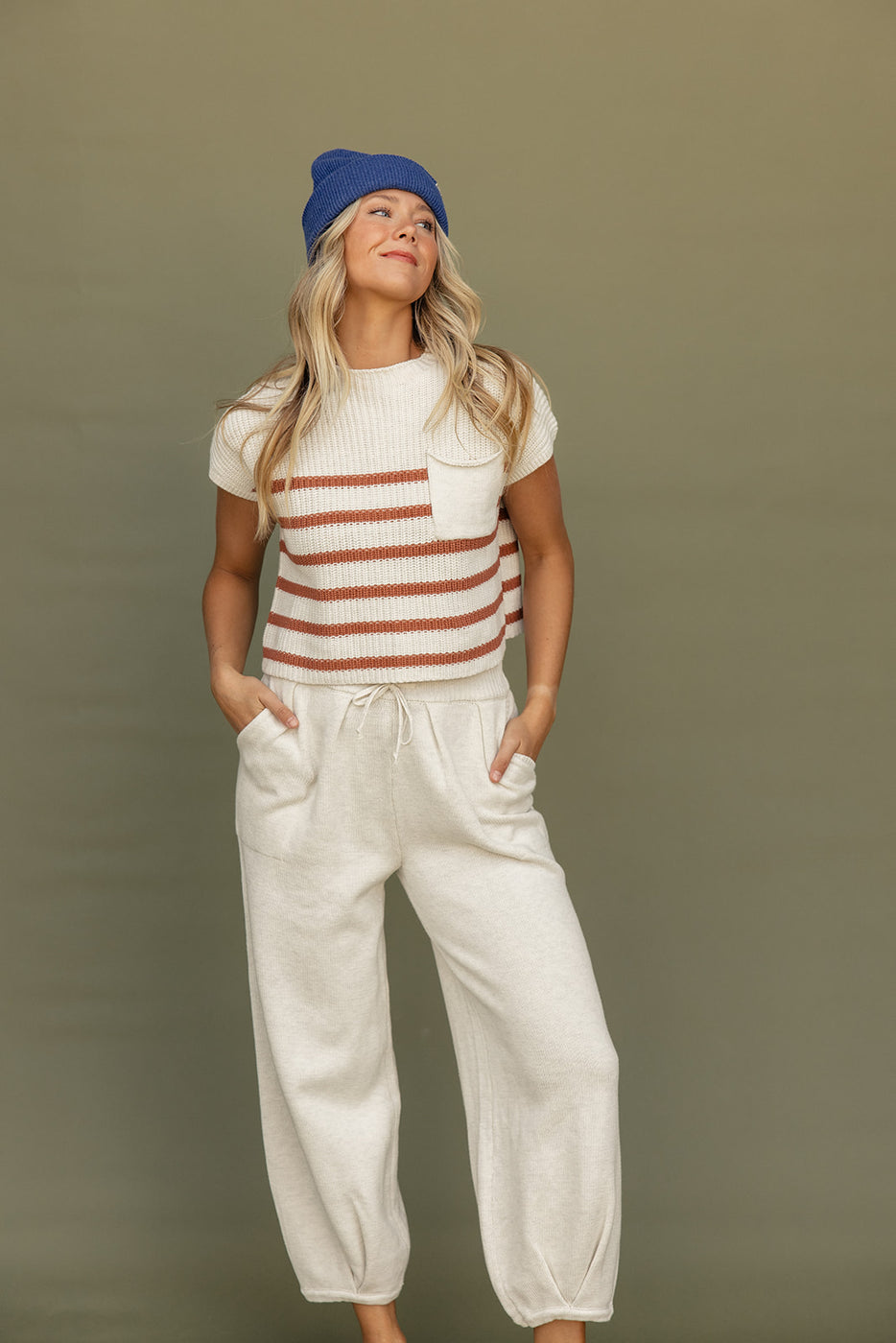 a woman wearing a hat and a striped shirt