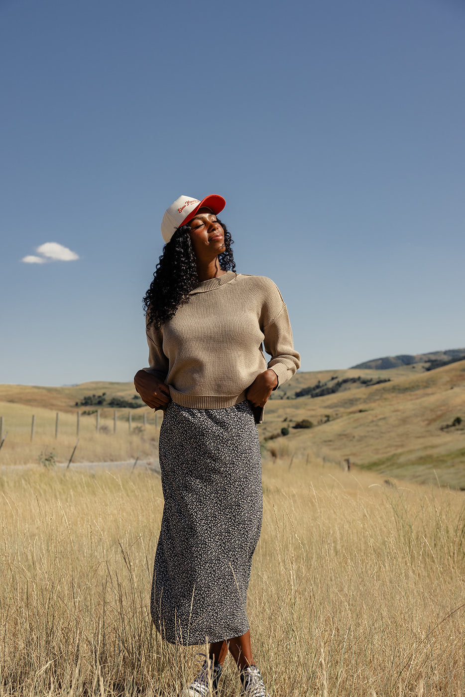 a woman standing in a field