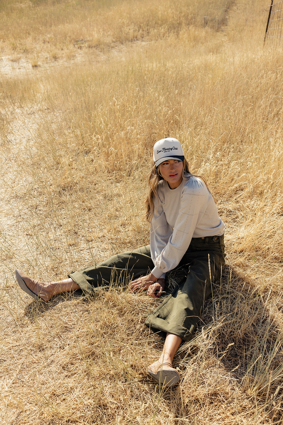 a woman sitting in a field