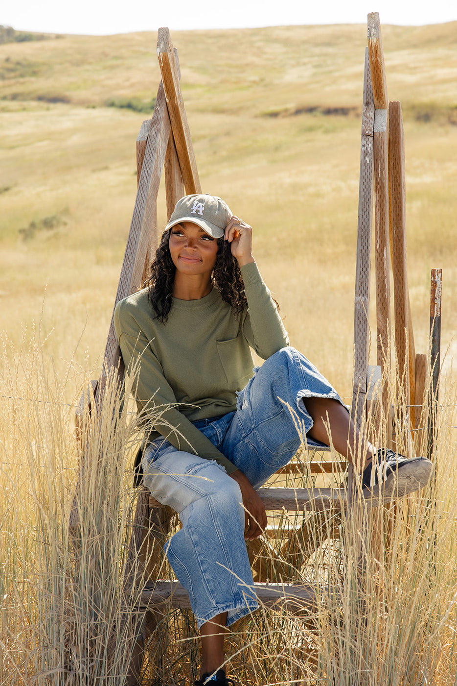 a woman sitting in a chair in a field