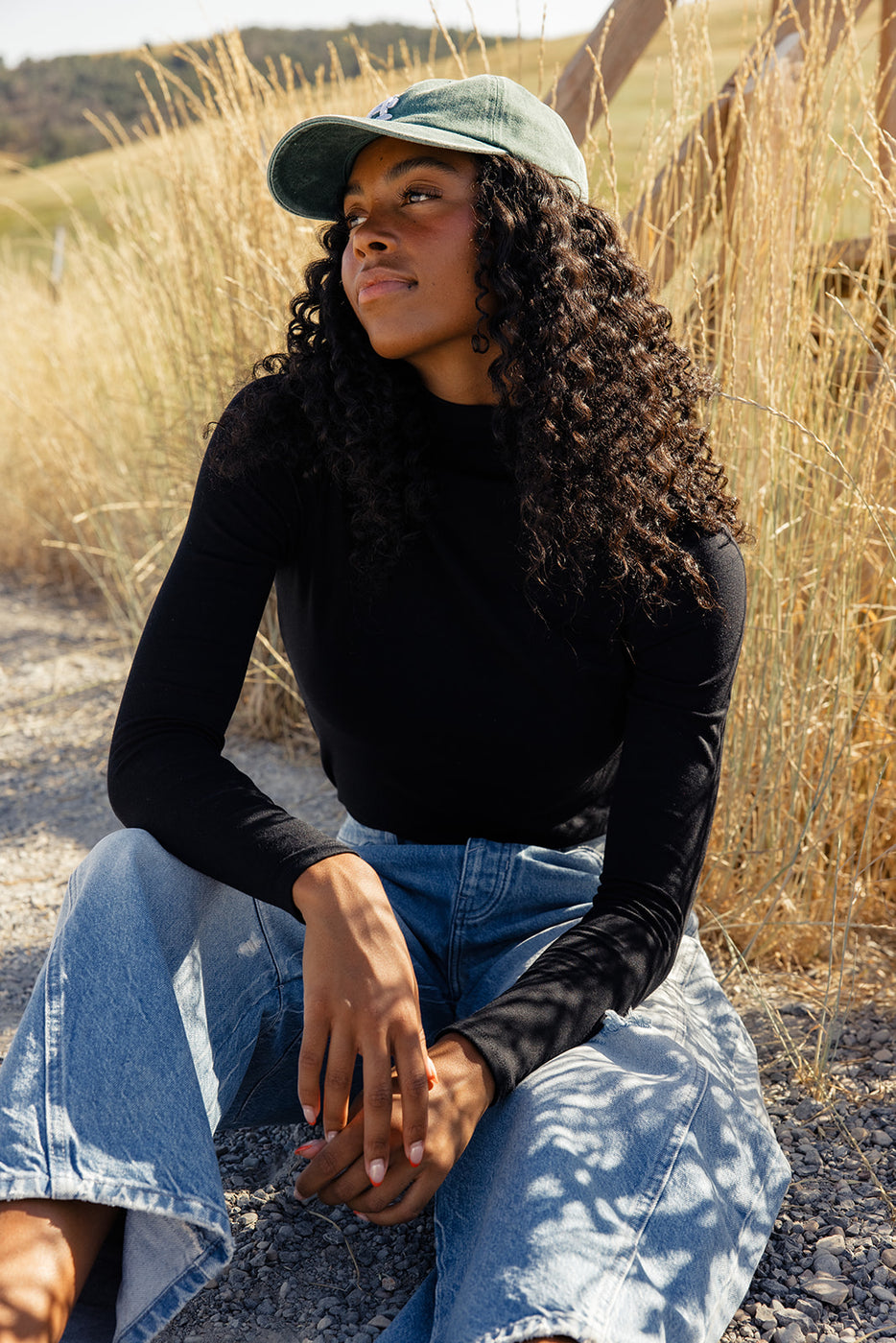 a woman sitting in a field