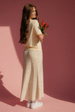 Woman holding flowers against a pink background