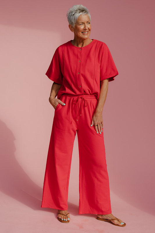 Woman wearing a red outfit on a pink background