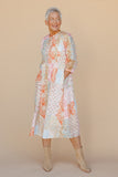 Woman wearing a floral dress against a beige background