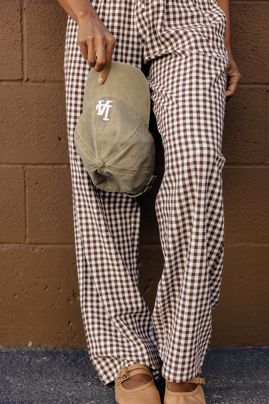 a person wearing plaid pants and a hat