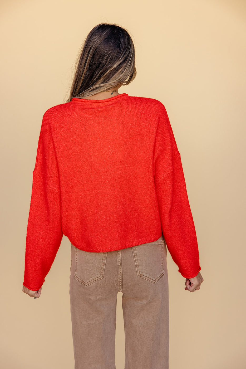 a woman wearing a red sweater