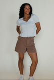 Woman wearing a summery outfit on a white background