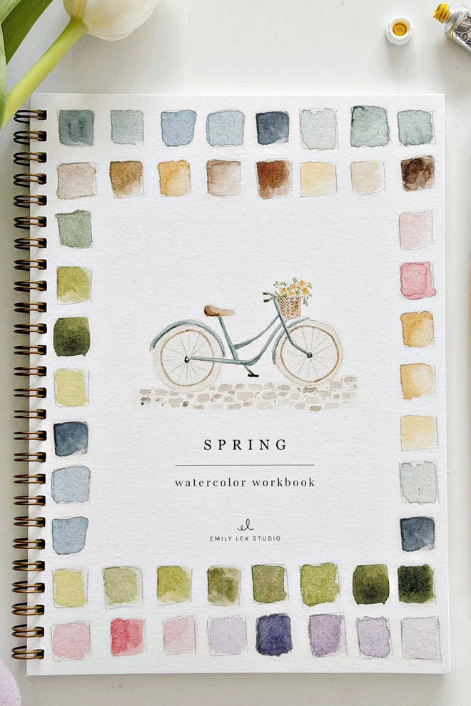 Spring watercolor workbook with a bicycle illustration and color swatches on a white background.