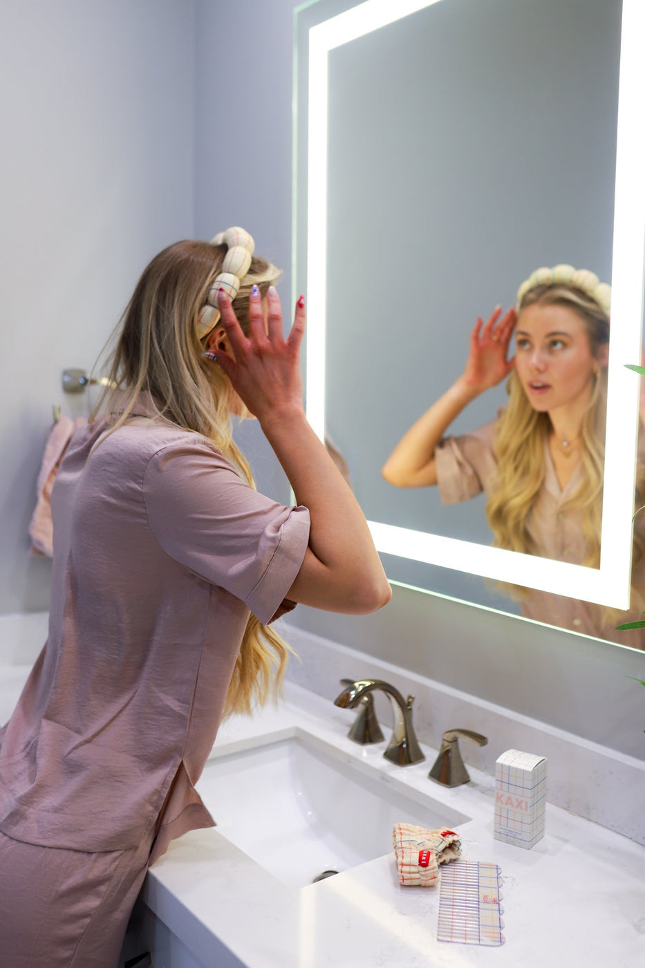 a woman looking in a mirror