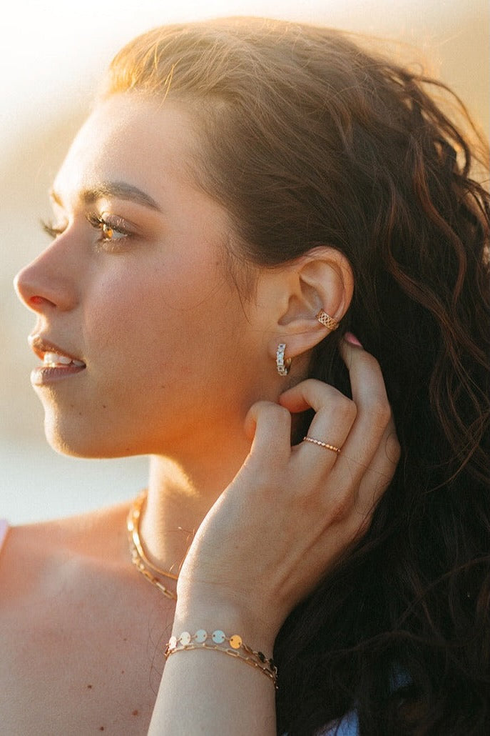 a woman with her hand on her ear