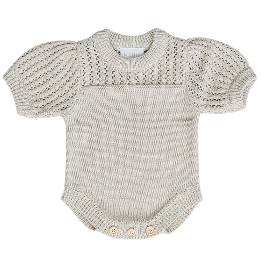 a white knitted baby bodysuit