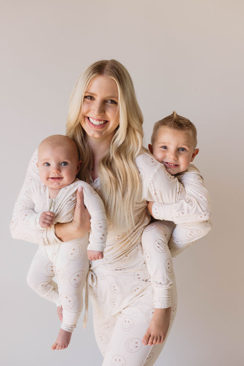 a woman holding two babies