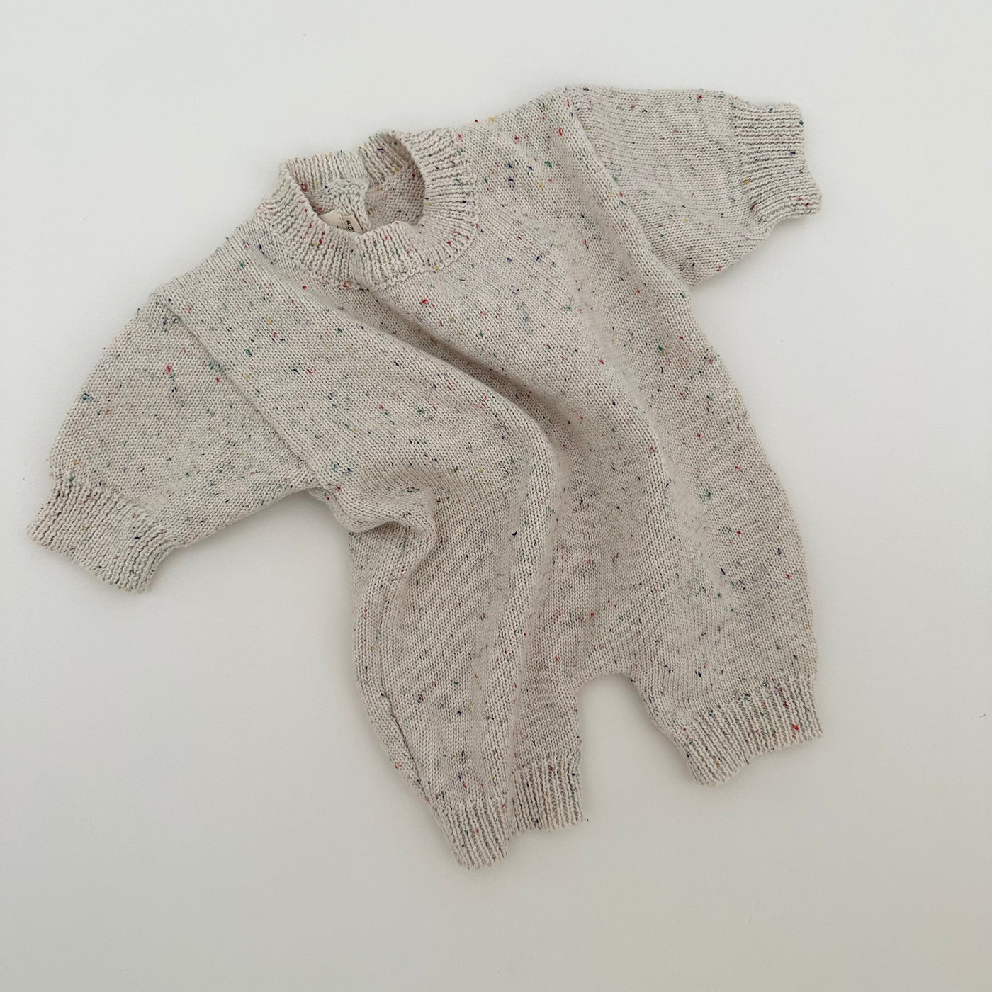 a sweater on a white surface