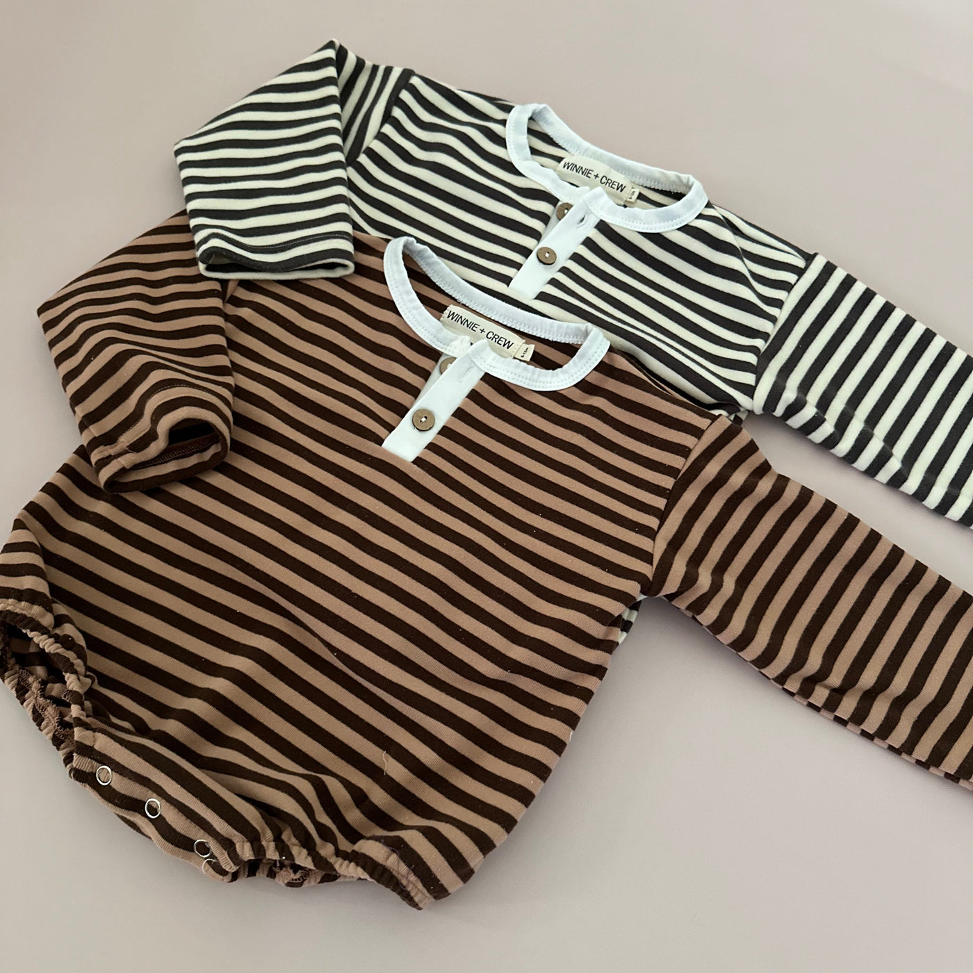 a pair of striped baby clothes