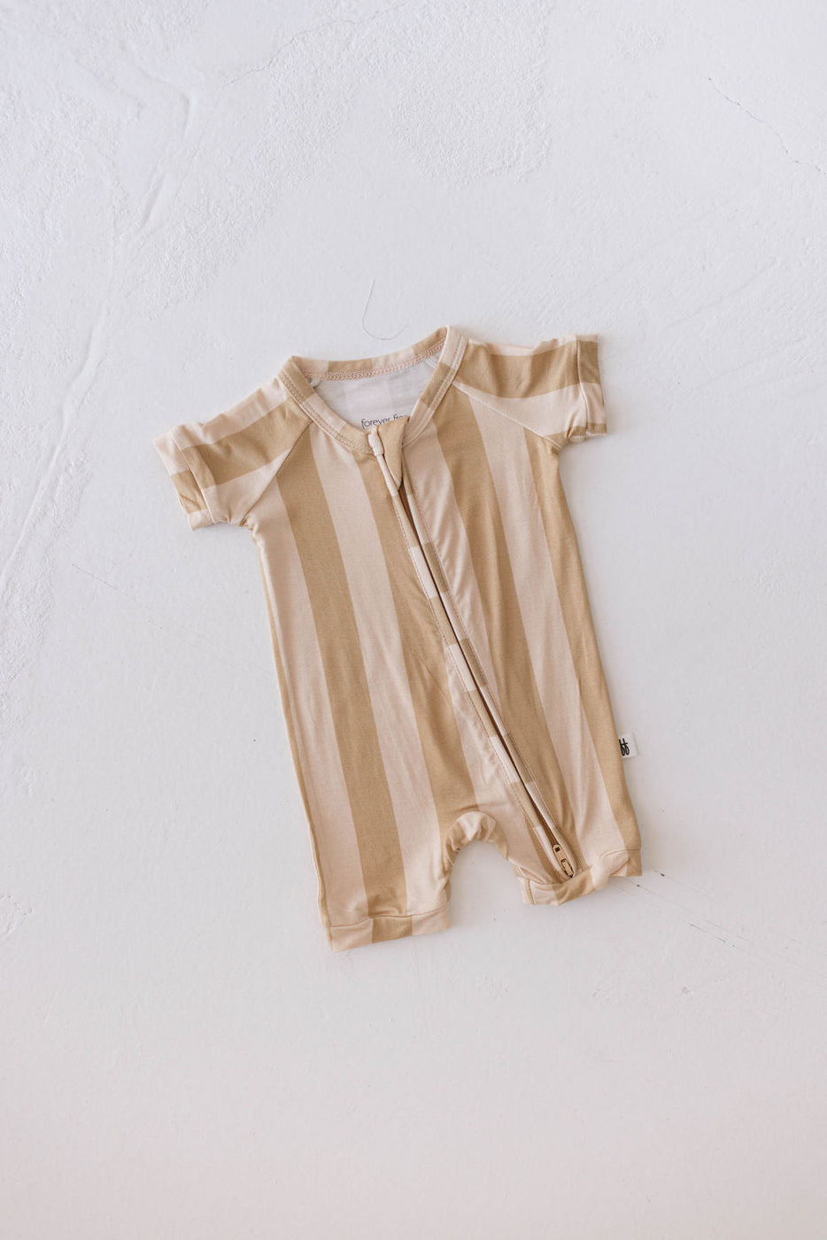 a baby romper on a white surface