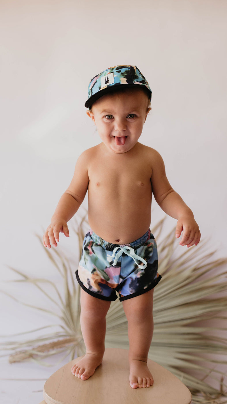 a baby wearing a hat and shorts