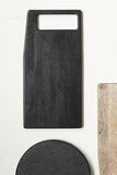 Set of black and wooden cutting boards on a white background