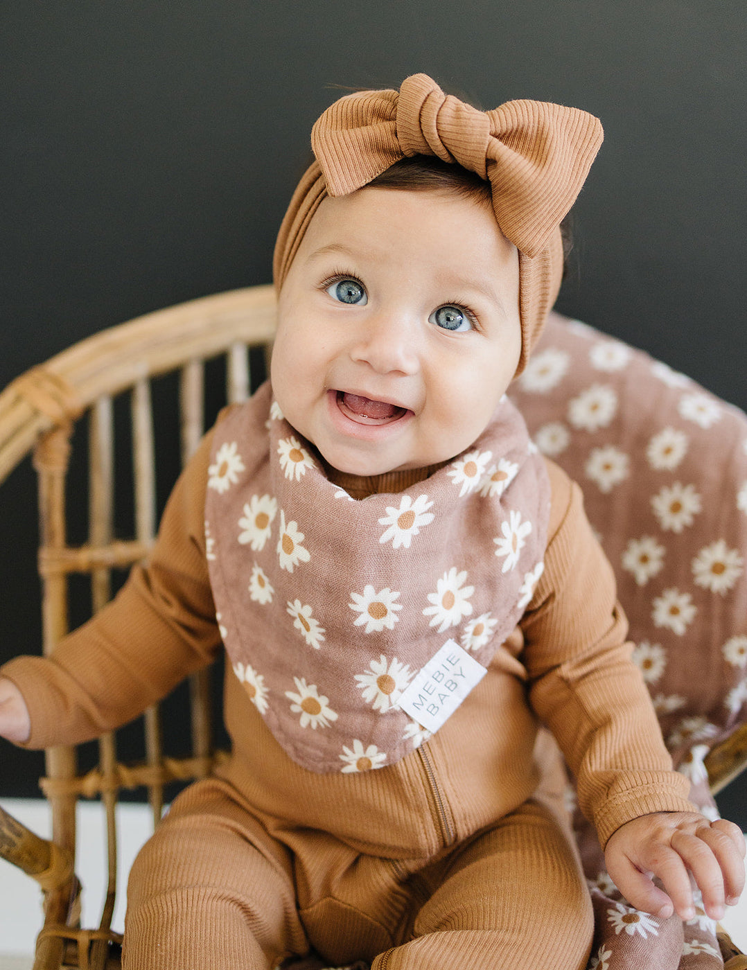 a baby wearing a bow and bib