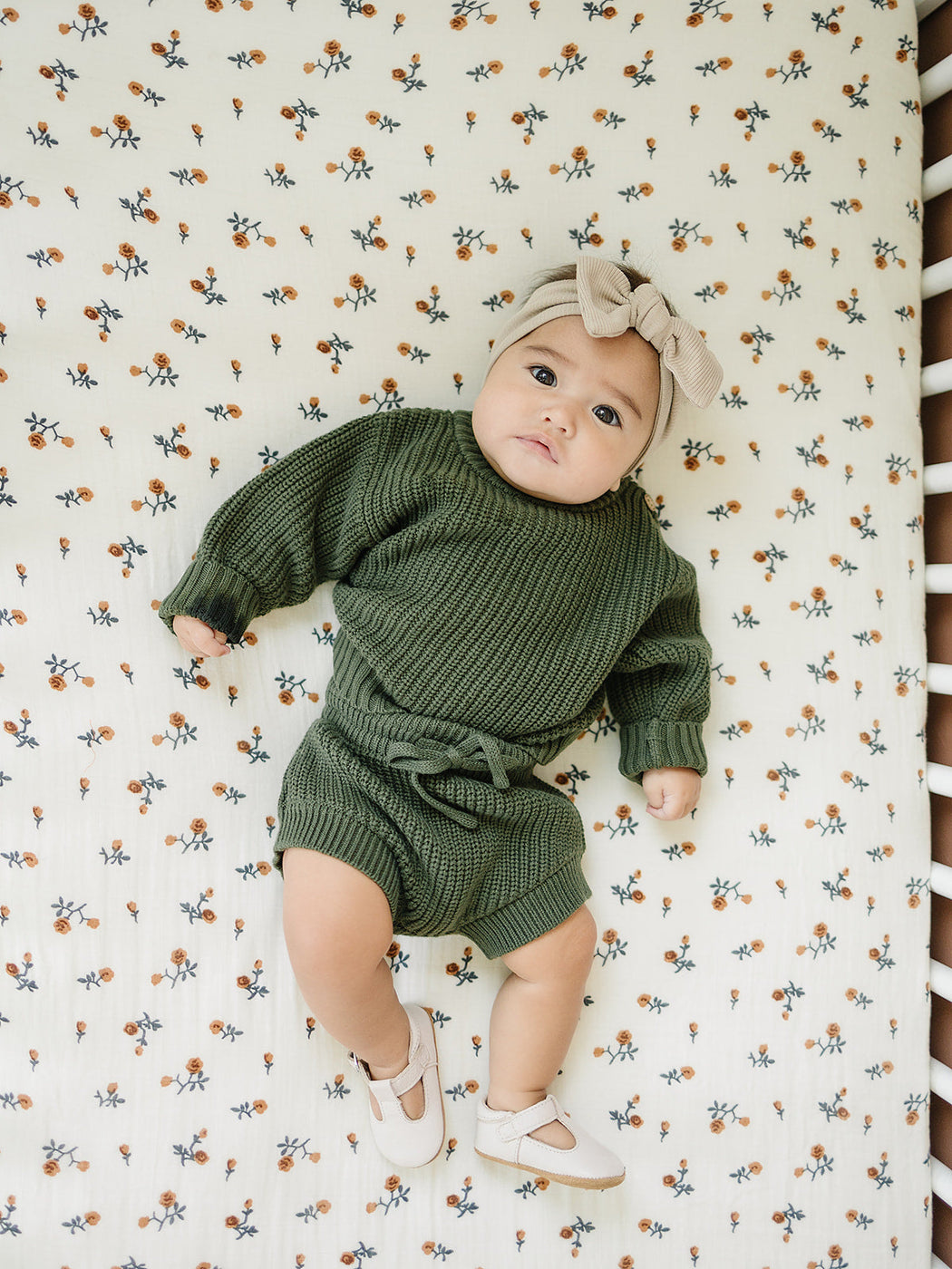 a baby lying on a crib