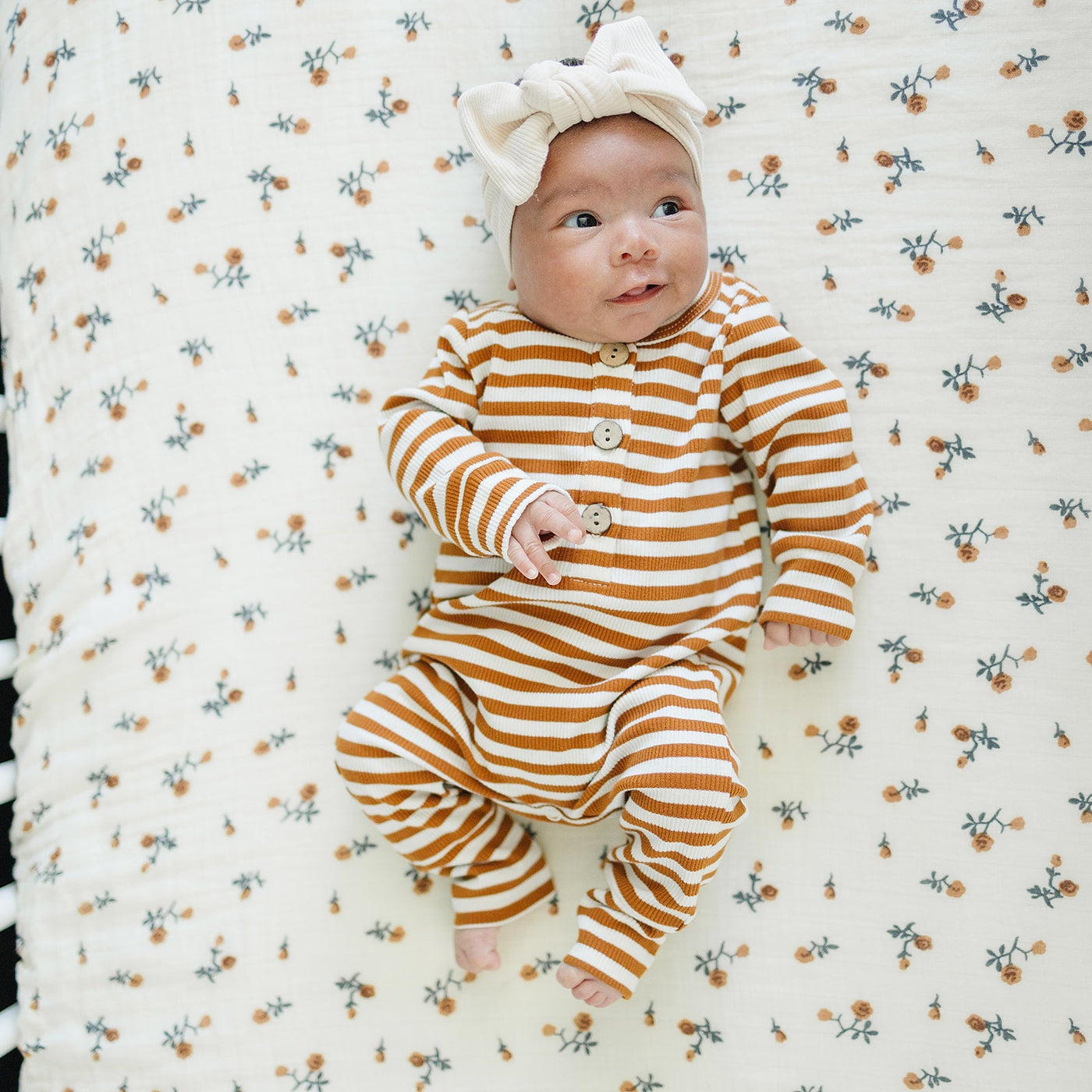 a baby lying on a crib