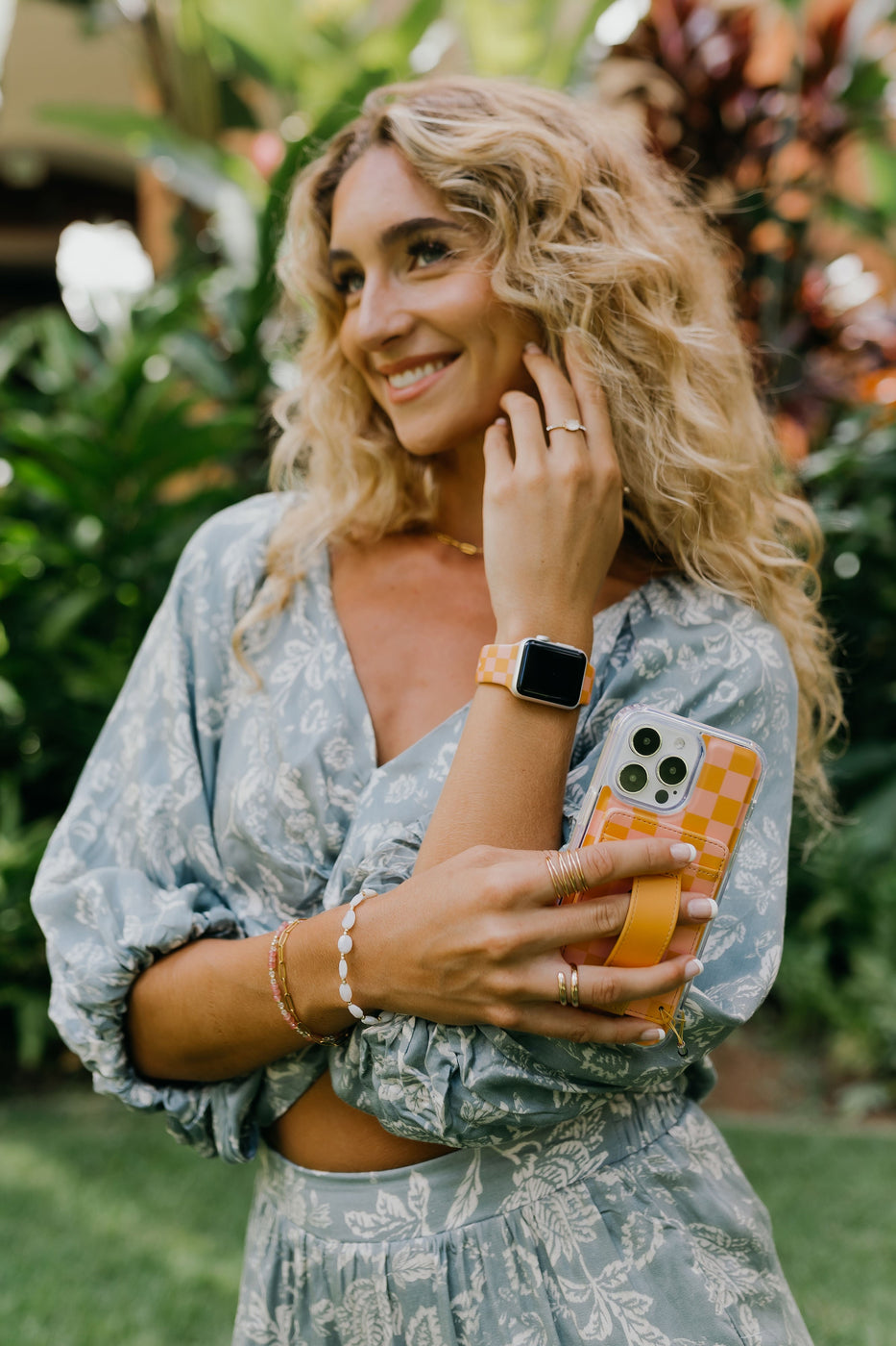 a woman holding a phone and smiling