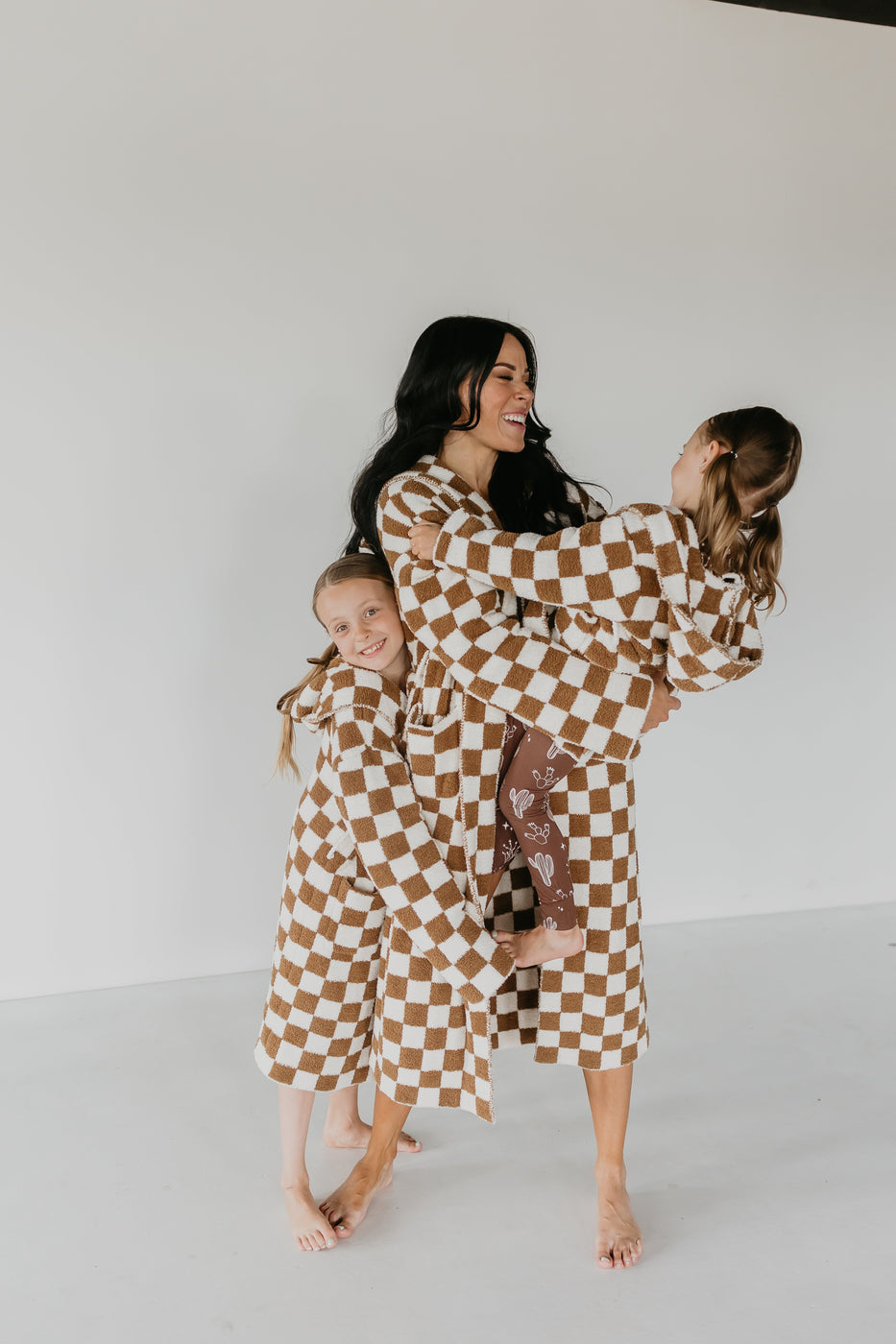 a woman holding two girls