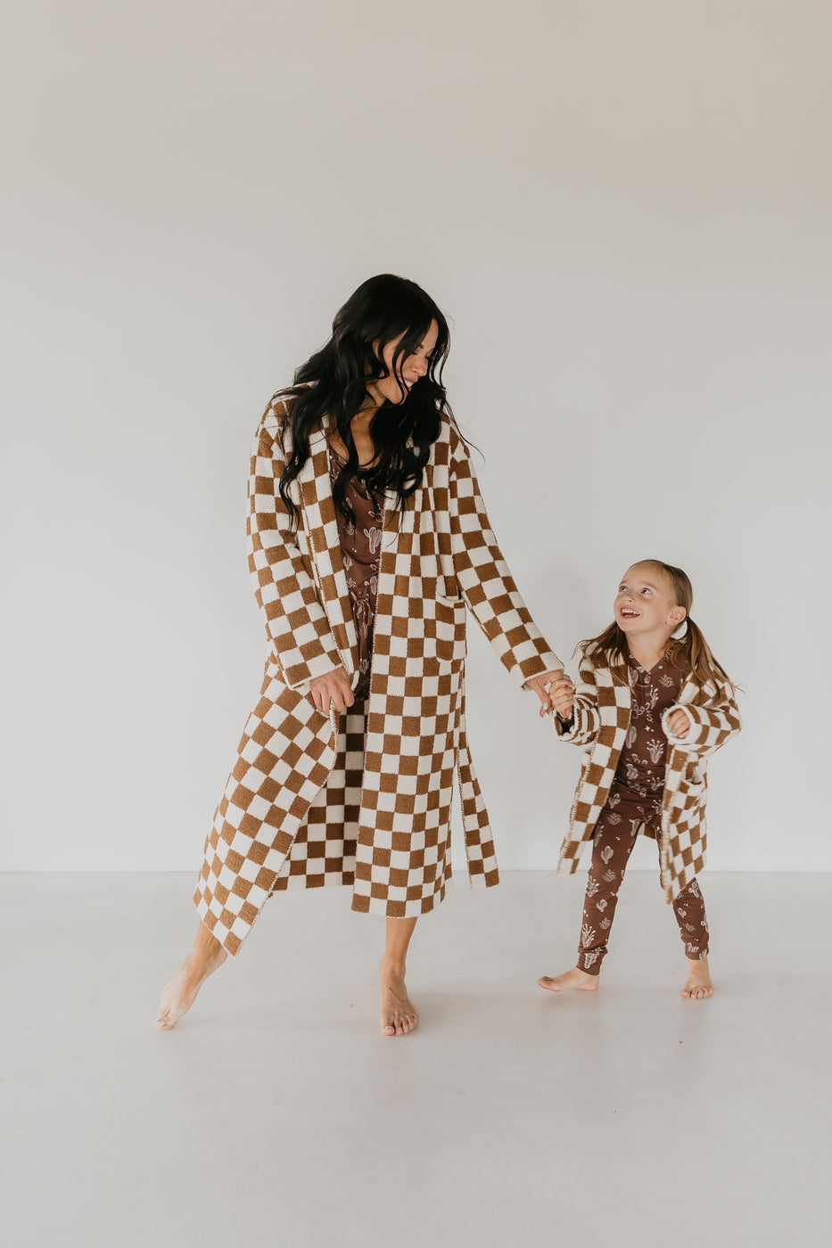 a woman and a girl holding hands