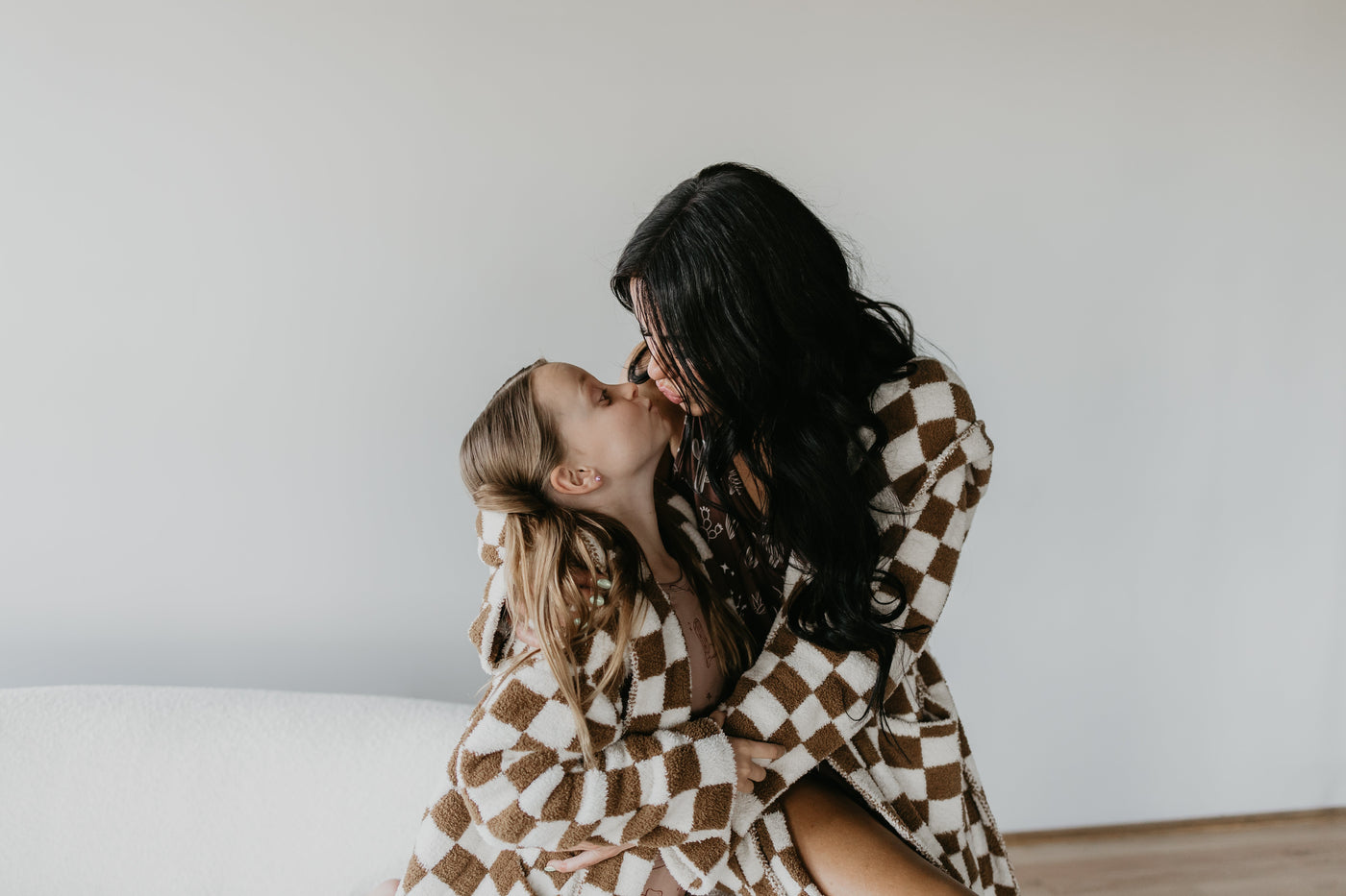 a woman and a girl kissing