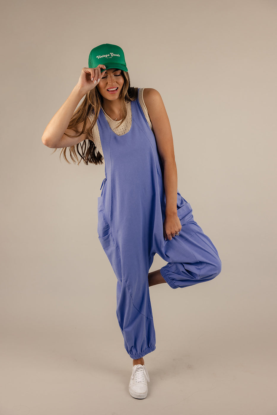 a woman wearing a hat and jumpsuit