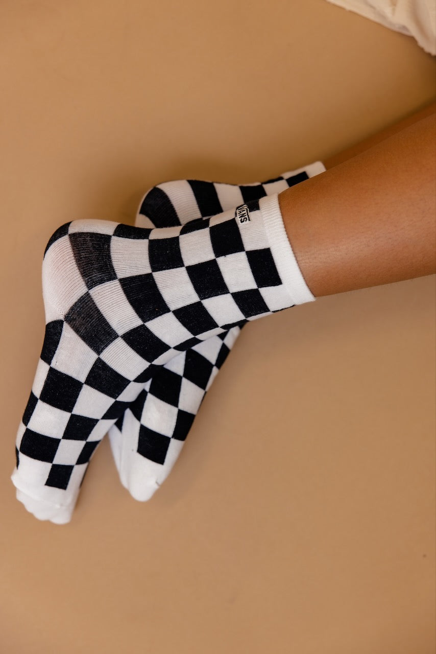 a pair of feet with checkered socks