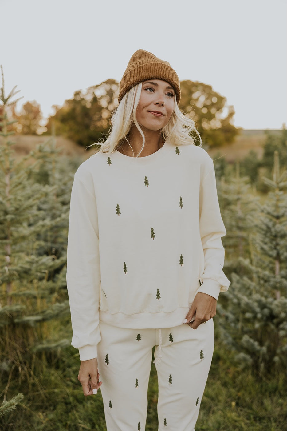 a woman wearing a hat and sweater