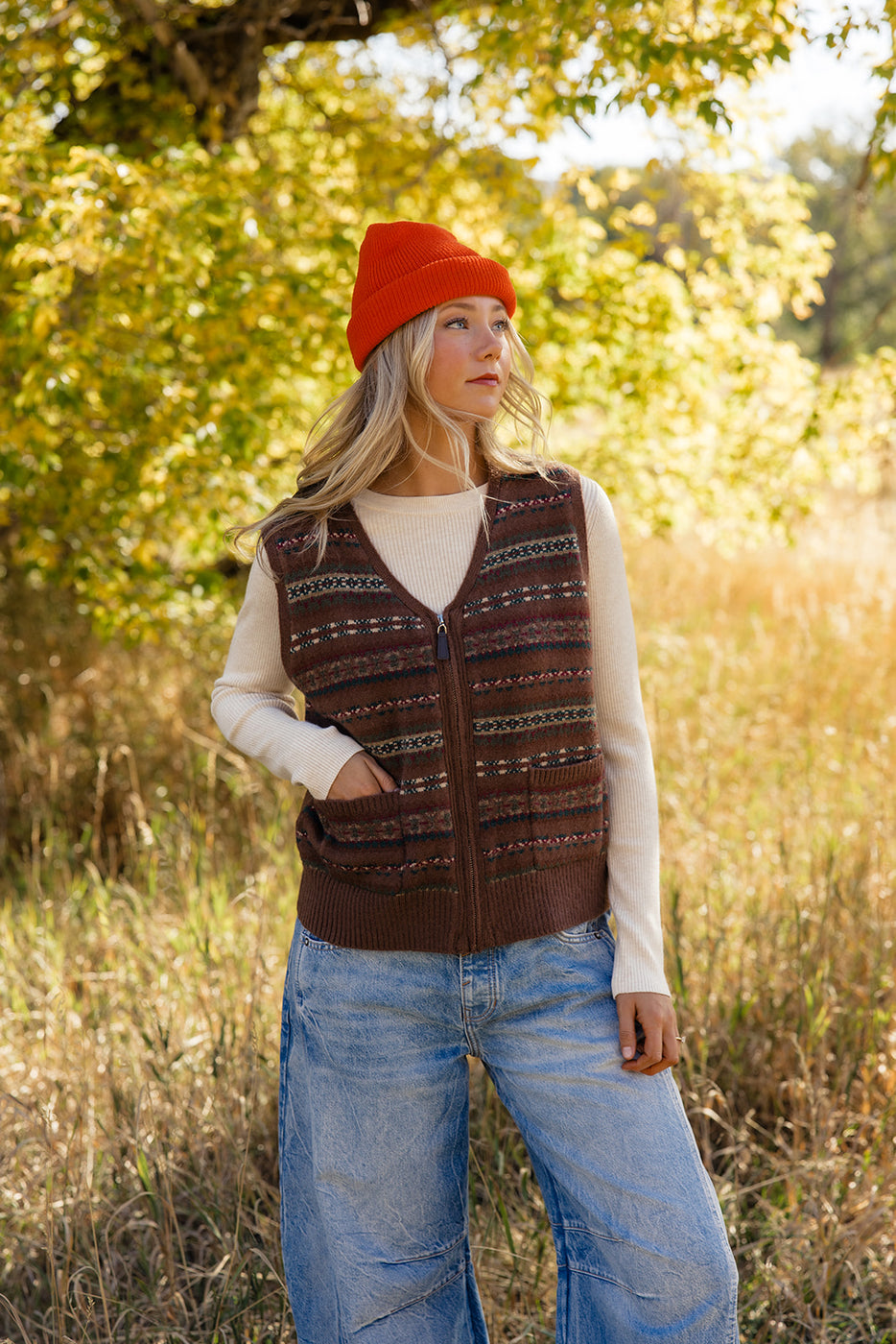 a woman in a hat and vest