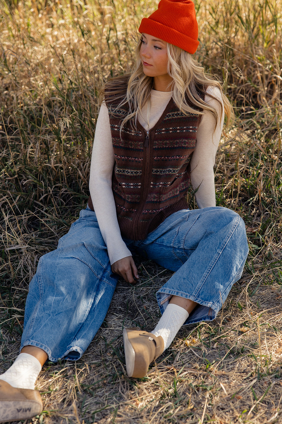 a woman sitting in a field