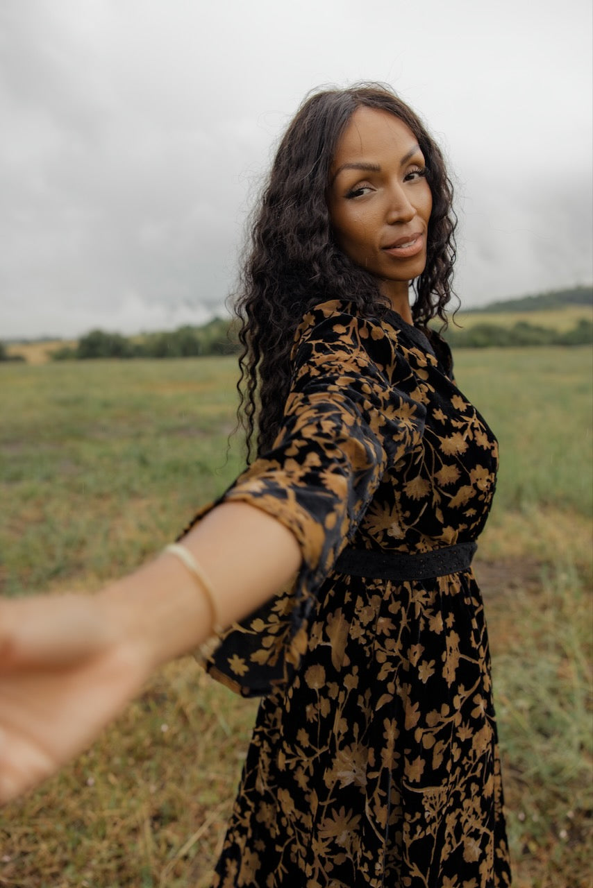 a woman taking a selfie in a field