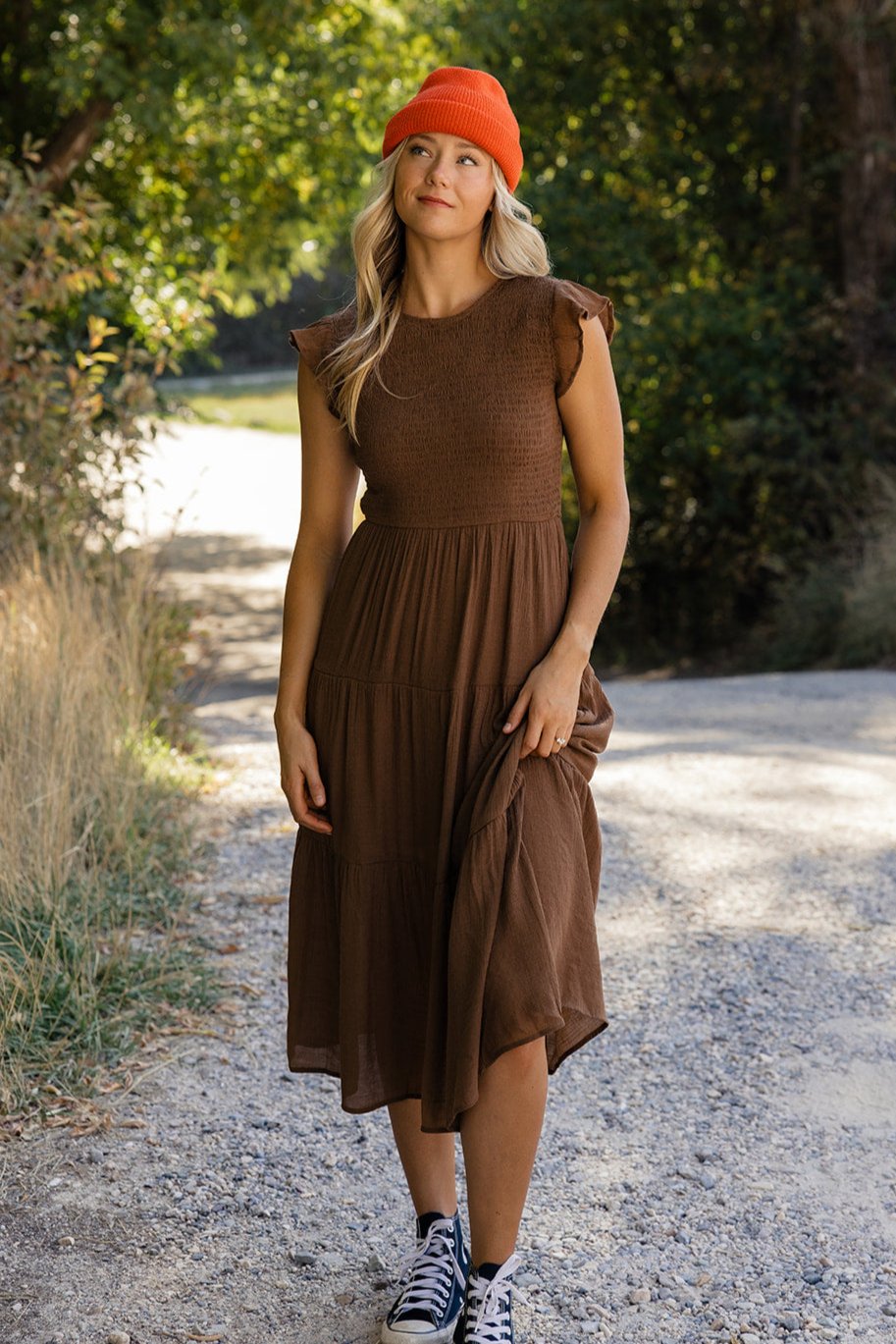 a woman in a brown dress