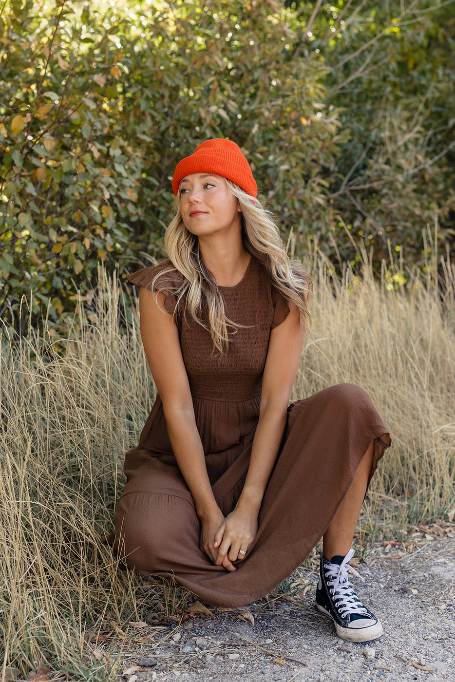 a woman sitting in tall grass