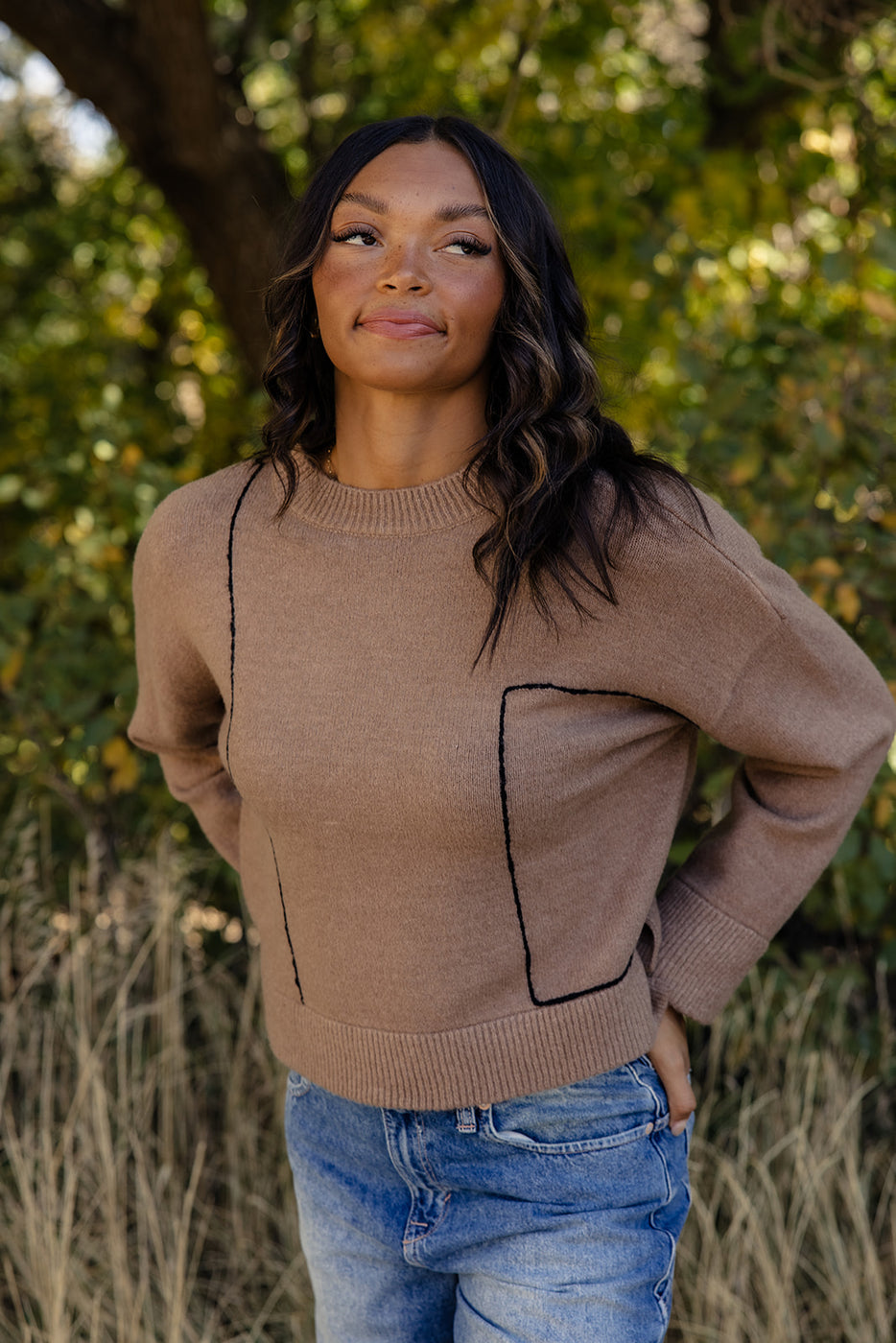 a woman in a brown sweater