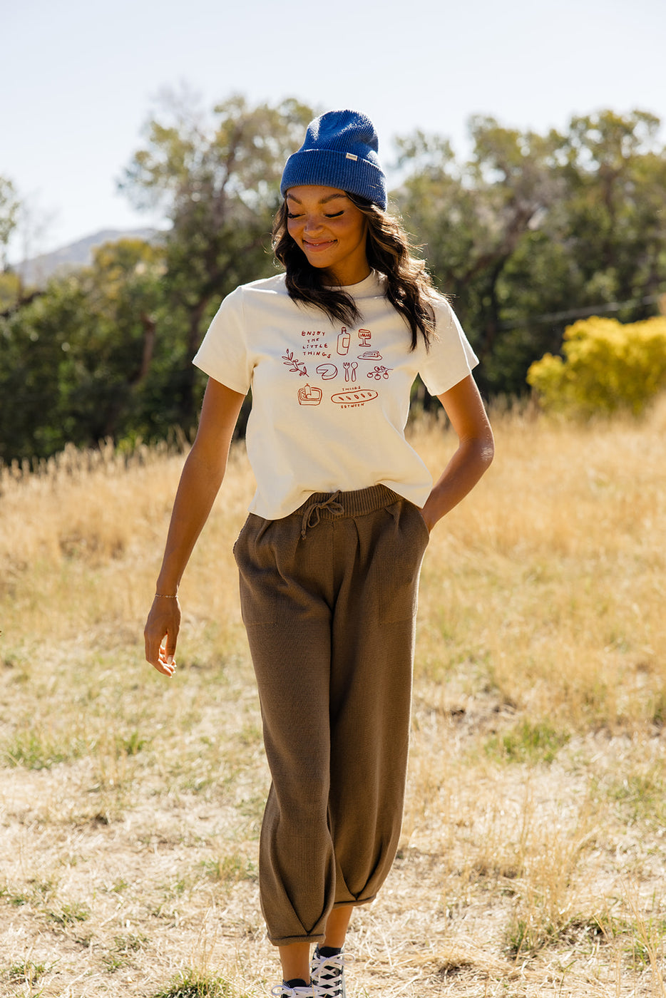 a woman in a hat and pants