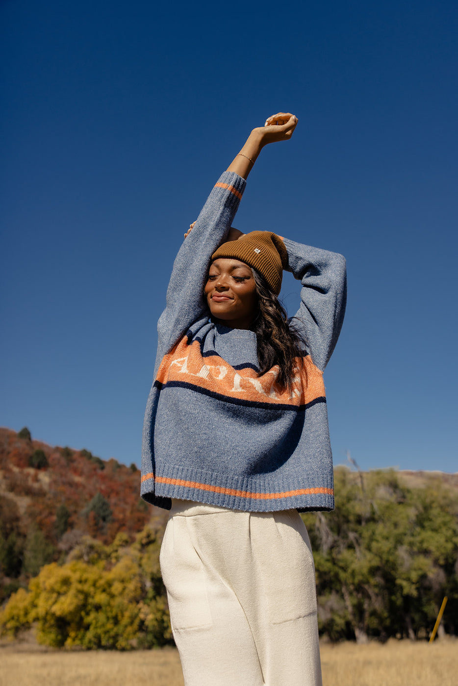 a woman with her arms raised in the air