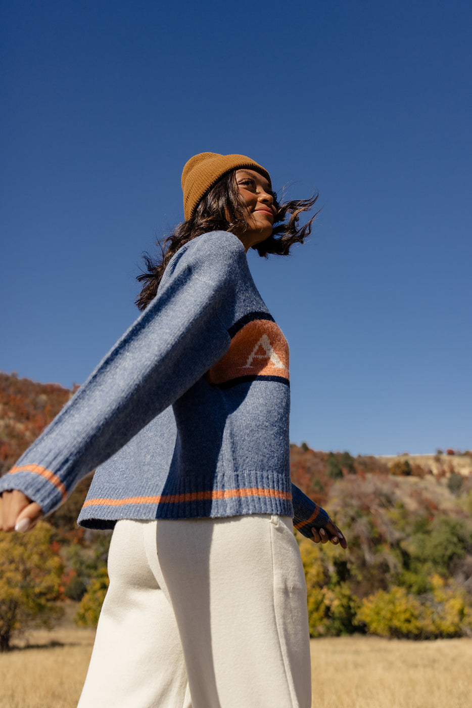 a woman wearing a sweater and hat