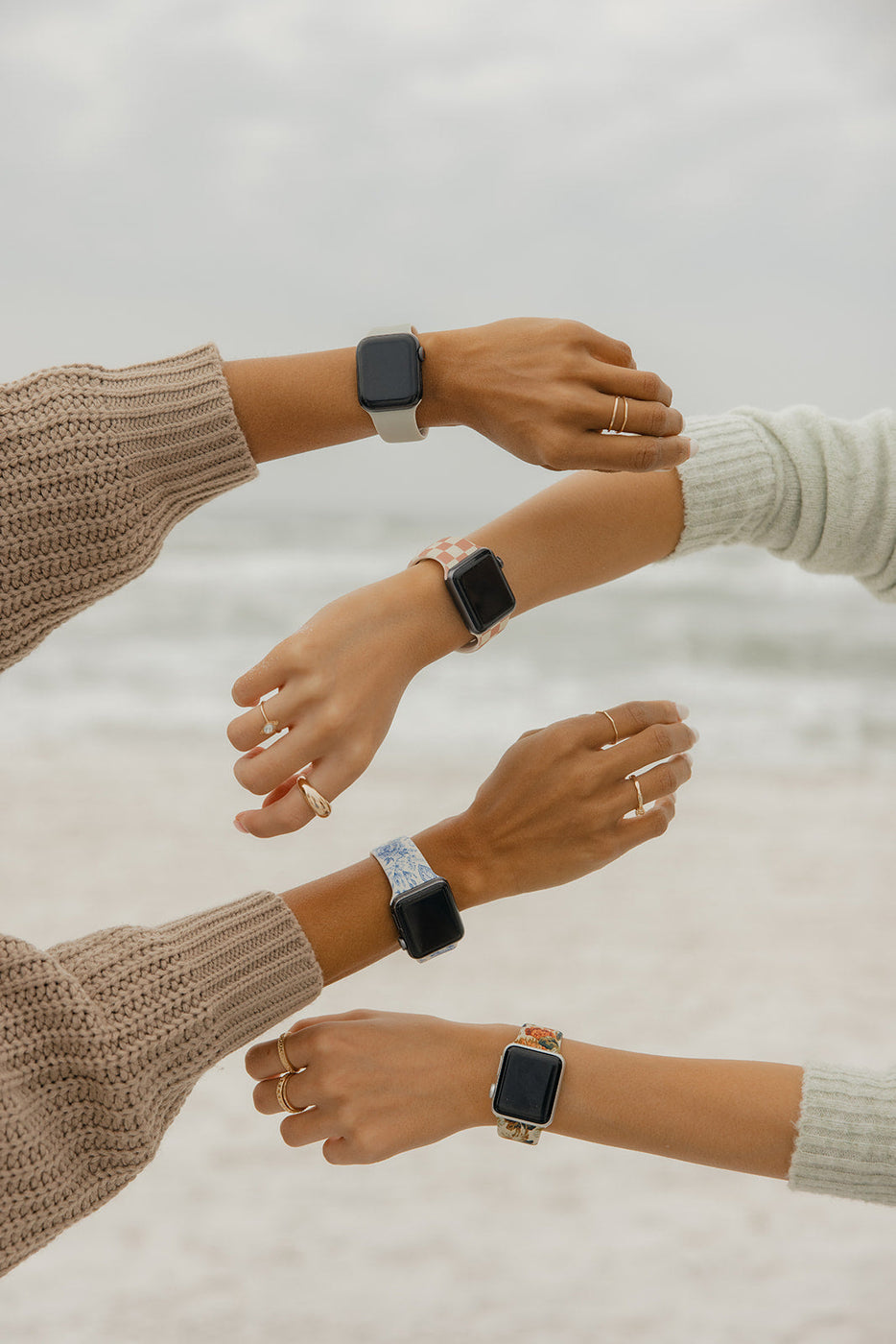 a group of hands with smart watches