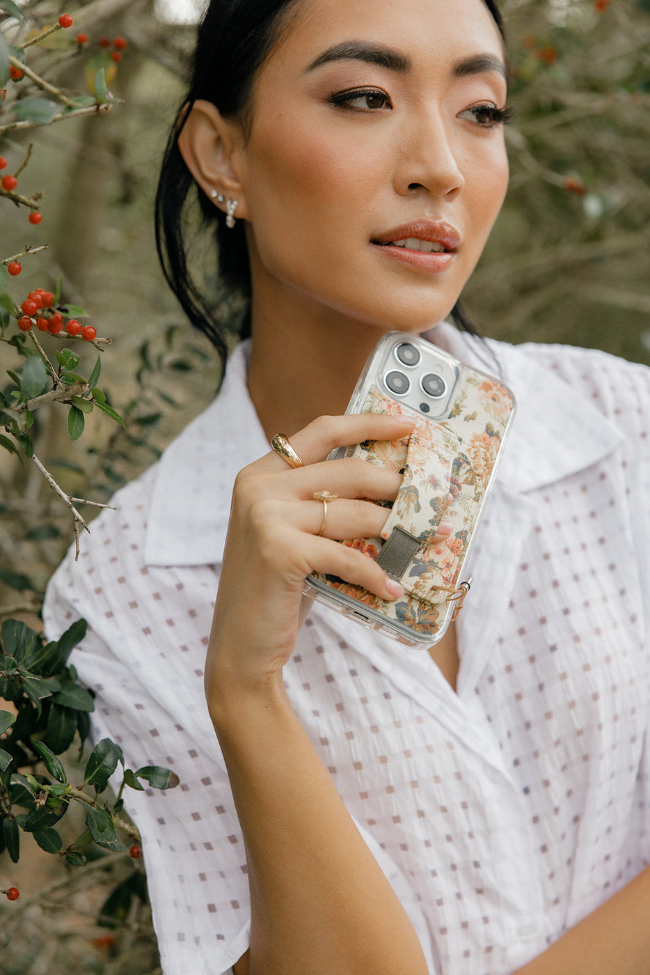 a woman holding a phone case