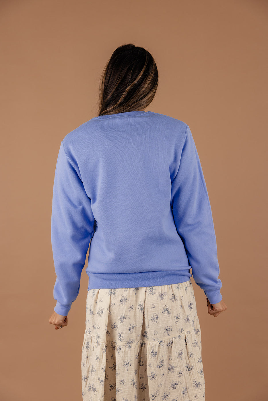 a woman wearing a blue sweater