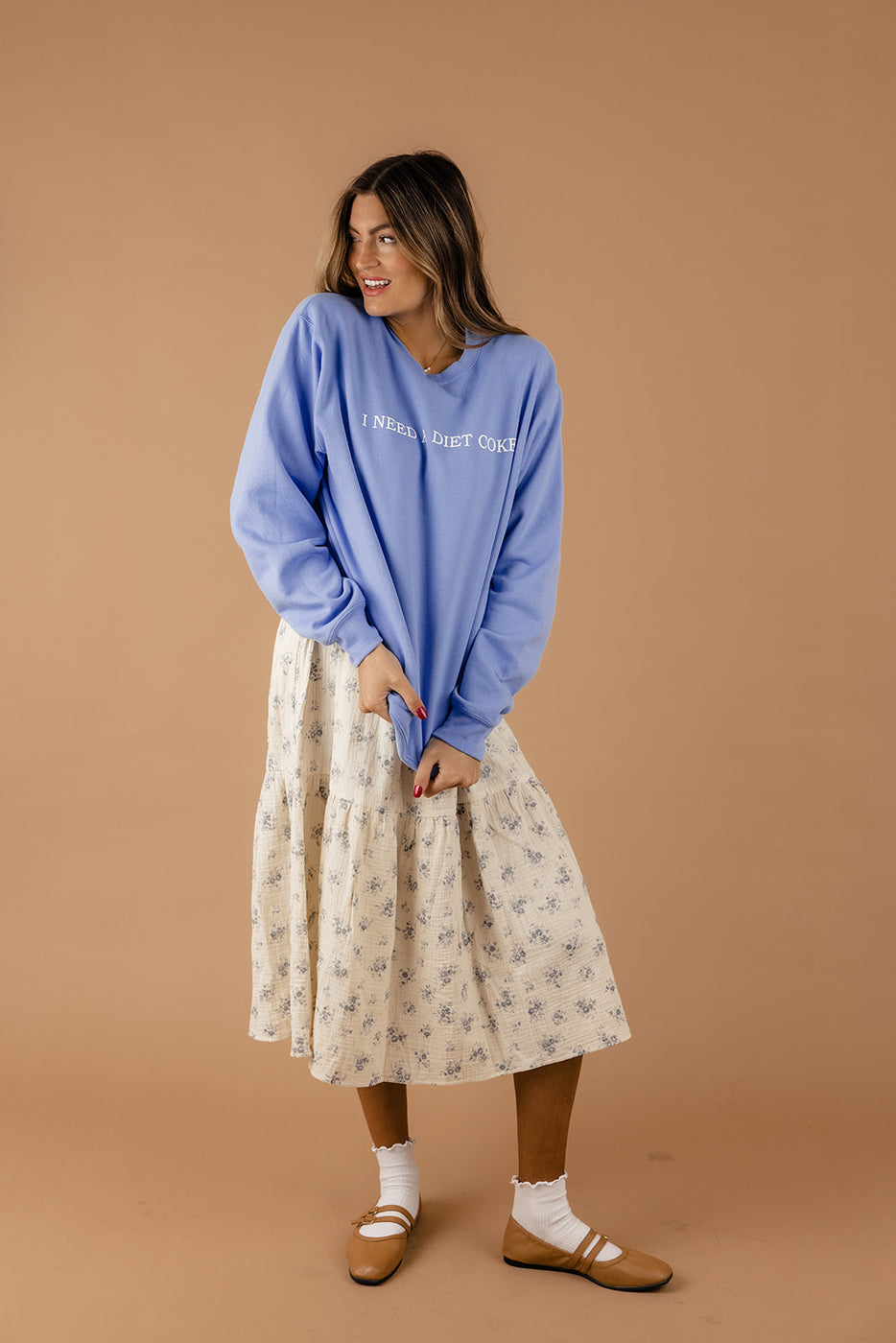 a woman in a blue sweater and skirt