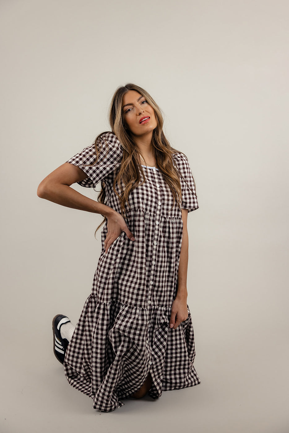 a woman in a checkered dress